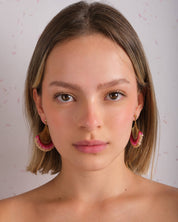 Woman wearing Mayana Designs Beaded Handwoven Flamenco Fan Earrings in Pink