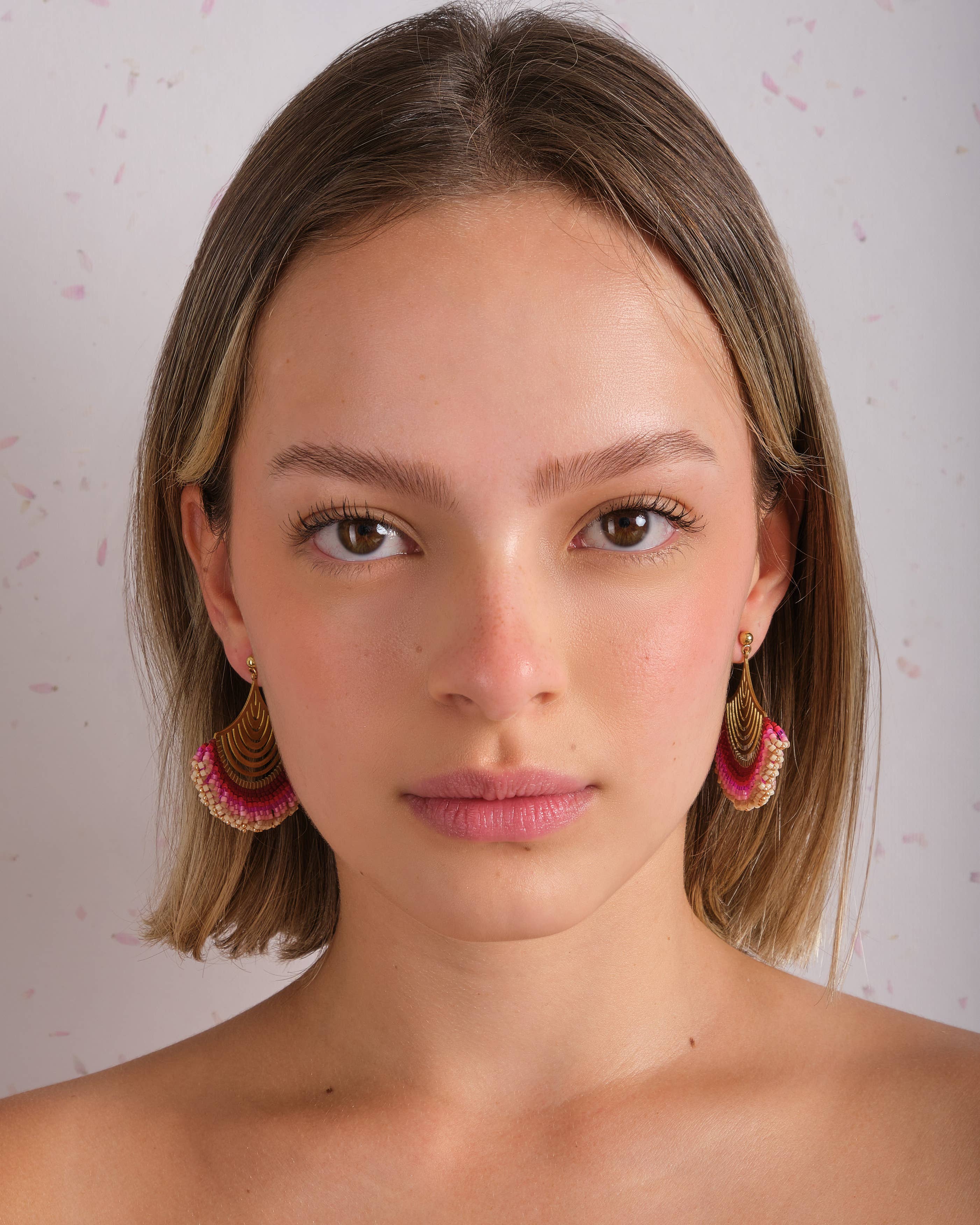 Woman wearing Mayana Designs Beaded Handwoven Flamenco Fan Earrings in Pink