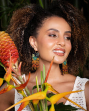 Woman wearing Mayana Designs Beaded Handwoven Jaguar Fringe Earrings, styled with a casual boho-chic outfit.