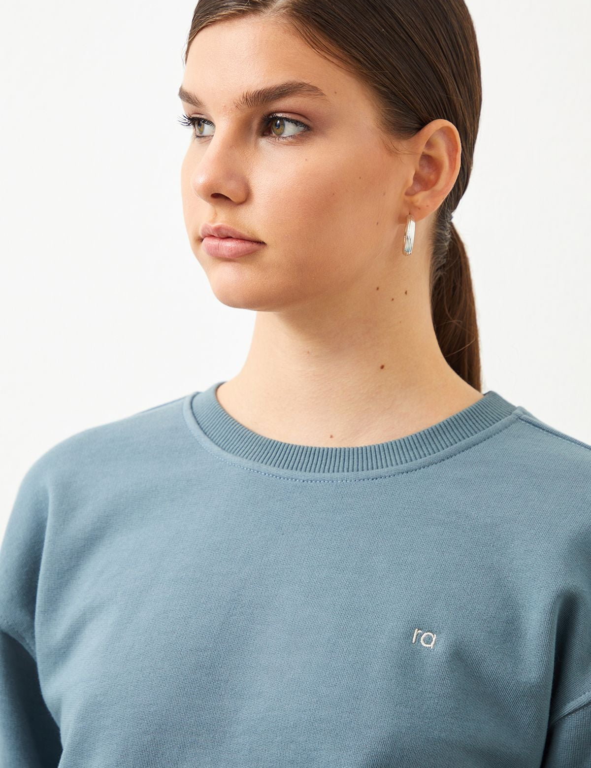 Woman wearing the  Ra Denim-Vita Crop Women's Sweatshirt in Blue