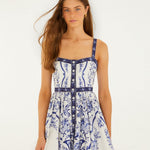 Model wearing Farm Rio off-white Porcelain Garden mini dress with hand-painted floral print, front view