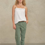 Front view of a model posing in a white bohemian-style cotton camisole from Mabe Apparel.