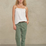 Front view of a model posing in a white bohemian-style cotton camisole from Mabe Apparel.