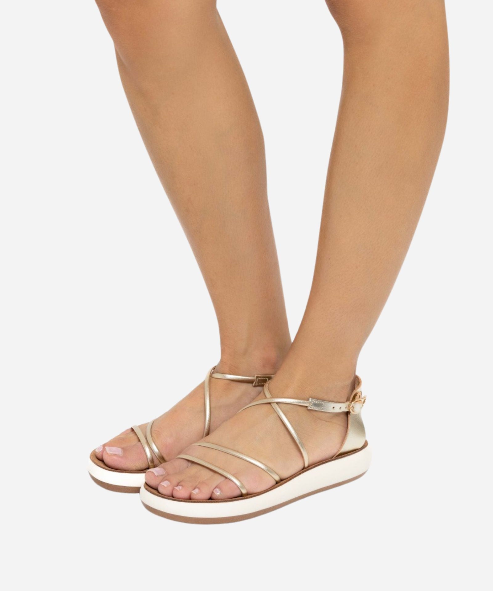 Ancient Greek Sandals Anastasia Comfort sandals in platinum worn on foot, showing the slim metallic crossover straps and cushioned cream sole