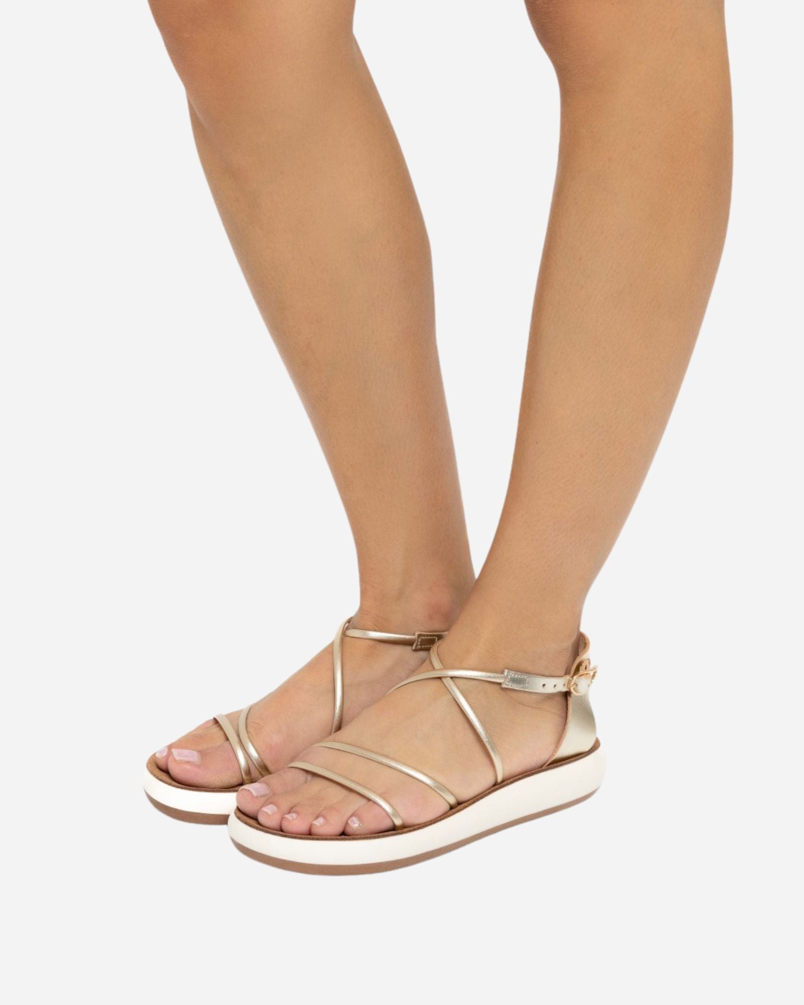 Ancient Greek Sandals Anastasia Comfort sandals in platinum worn on foot, showing the slim metallic crossover straps and cushioned cream sole