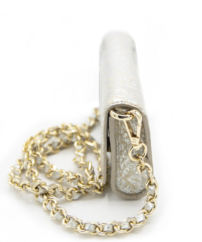 A side profile of the Ary Bag, highlighting its compact dimensions and elegant gold chain strap.
