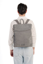 Young Man wearing the Emmy Boo Grey Suede Backpack Lipari  with adjustable shoulder straps.