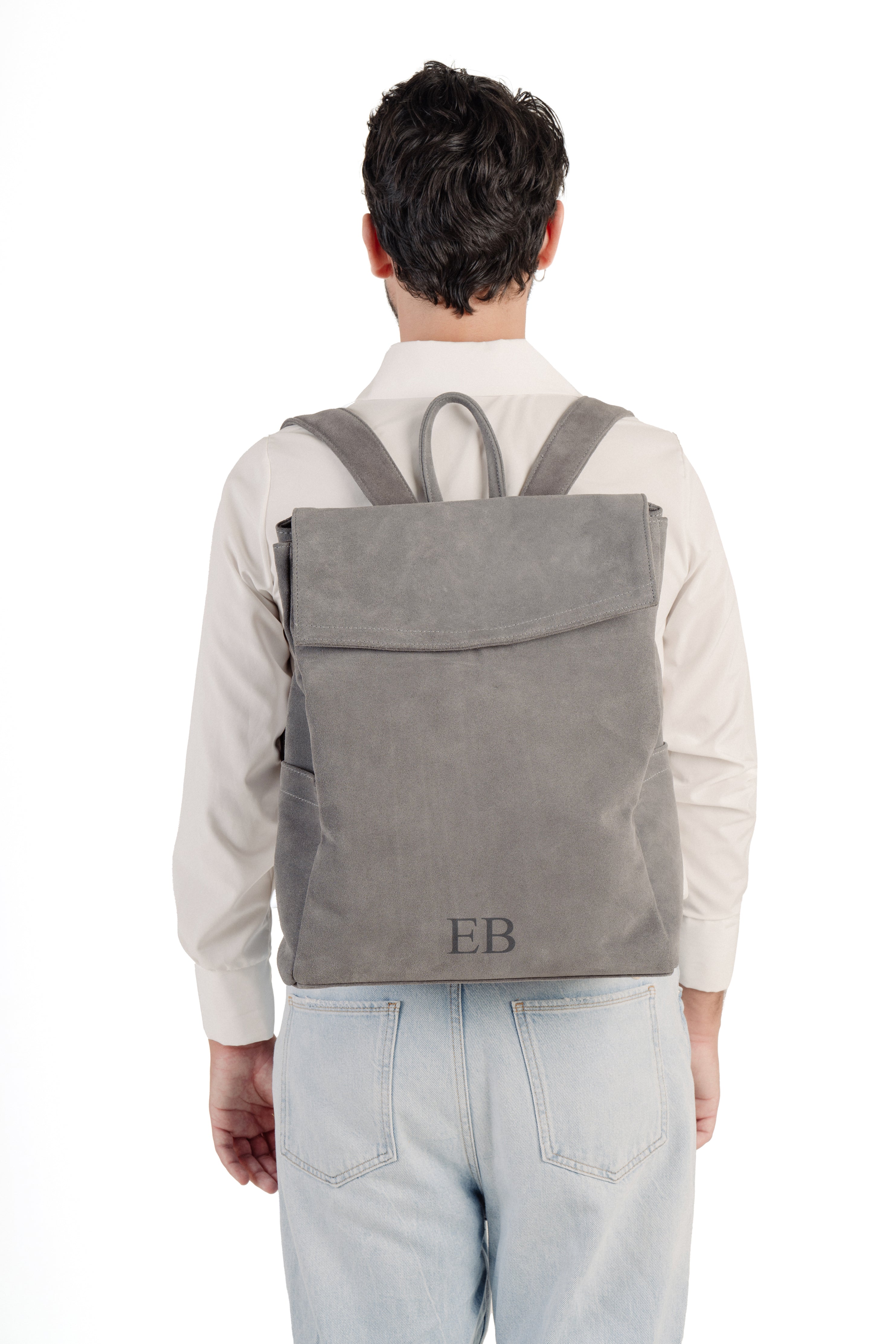 Young Man wearing the Emmy Boo Grey Suede Backpack Lipari  with adjustable shoulder straps.