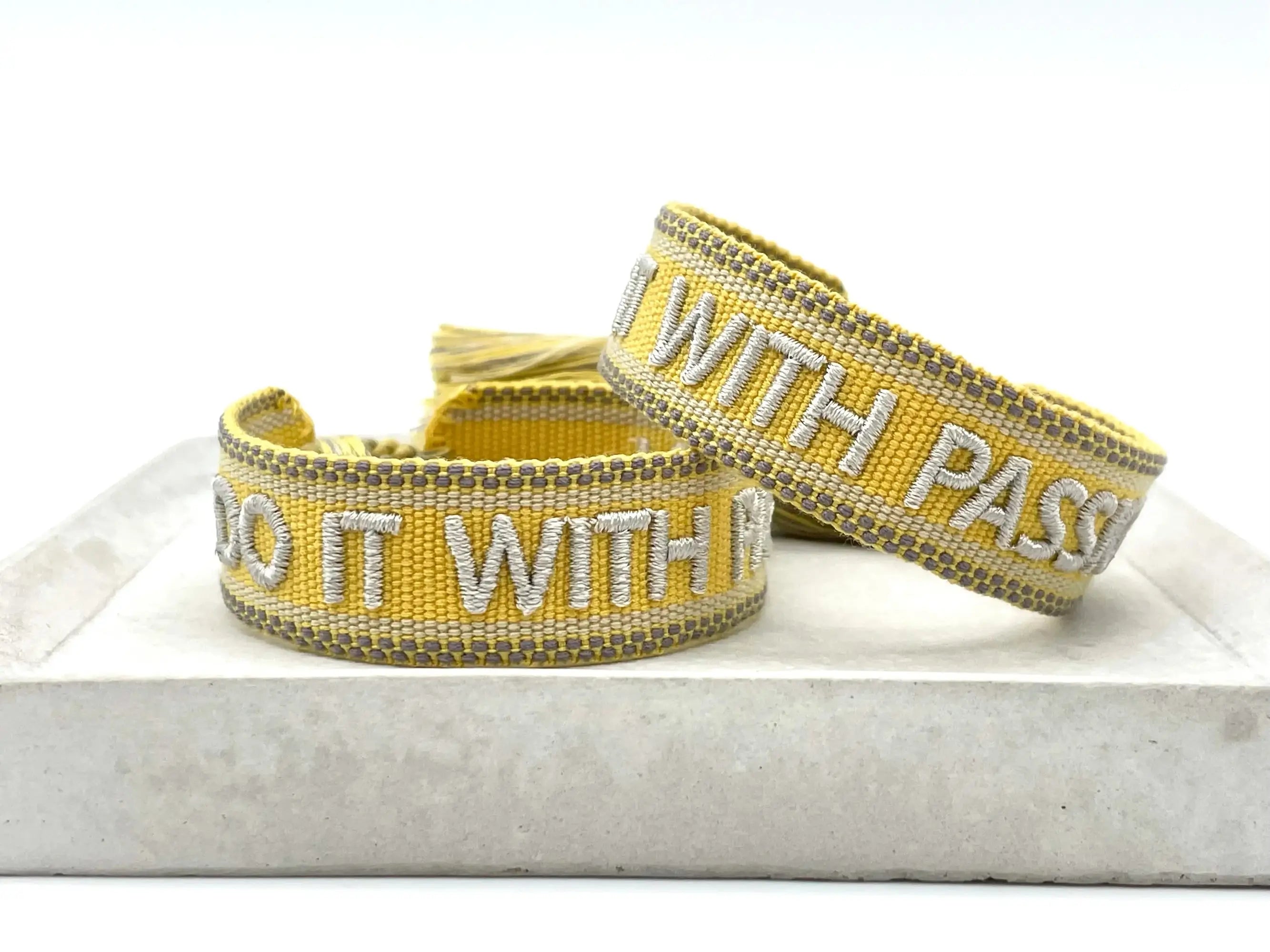 Sunshine yellow woven bracelet with "Do It With Passion" silver embroidery.