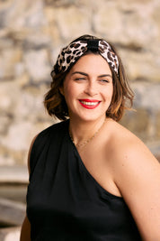 Woman wearing a leopard printed hairband by KS Vestiaire and black top.