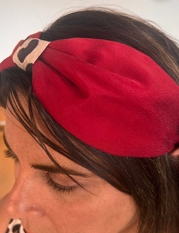 Woman with brown hair wearing chic red headband 