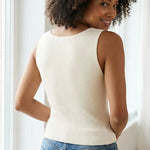 Back view of a woman wearing an off-white organic cotton rib knit tank top with a sleeveless, slim fit.