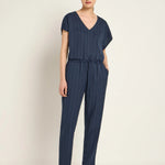 Woman wearing a navy blue striped jumpsuit by Lanius Fair Fashion - office essentials