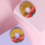 Close-up of Mayana Designs Lilac Circle Fringe Earrings, showcasing the intricate beadwork and hammered brass arch