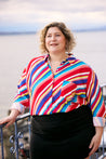 Beautiful woman wearing colourful summer shirt and black mini skirt by Swiss Fashion brand KS Vestiaire Intemporel