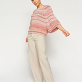 Model wearing MMEdele Knit Pullover in Peachy, side view with relaxed oversized fit