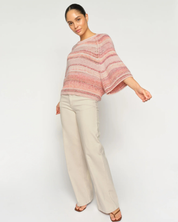Model wearing MMEdele Knit Pullover in Peachy, side view with relaxed oversized fit