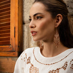 Woman wearing Mayana Designs Taos Fringe Earrings in Light Brown, showcasing their elegant geometric design and fringe details