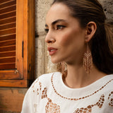 Woman wearing Mayana Designs Taos Fringe Earrings in Light Brown, showcasing their elegant geometric design and fringe details