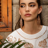 Woman wearing Mayana Designs Beaded Handwoven Taos Fringe Earrings in Light Brown.