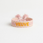 Close-up of adjustable salmon woven boho bracelet with offwhite border and orange embroidered “MORE VEUVE PLEASE” lettering, featuring sliding knot tassel cords.