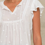 Front view of embroidered camisole in white with relaxed fit