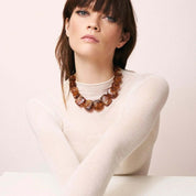 Model wearing the Big Organic Shaped Necklace in bold amber by Vanessa Baroni