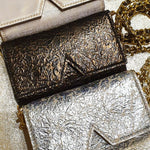 Aetalia Ary evening bag in bronze between the silver and gold versions, flap with the signature A cut-out