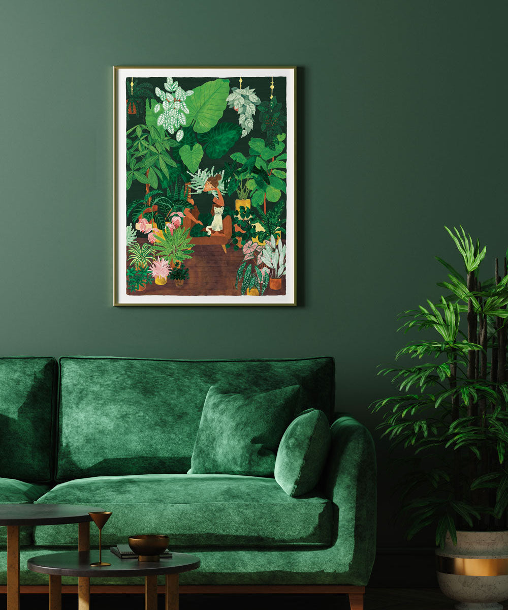Plant Addict Lady poster by All the Ways to Say framed above a green velvet sofa
