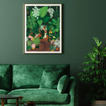 Plant Addict Lady poster by All the Ways to Say framed above a green velvet sofa