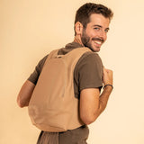 Model wearing the ARSAYO Mela backpack in beige AppleSkin