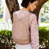 Model wearing the ARSAYO Mela backpack in beige AppleSkin