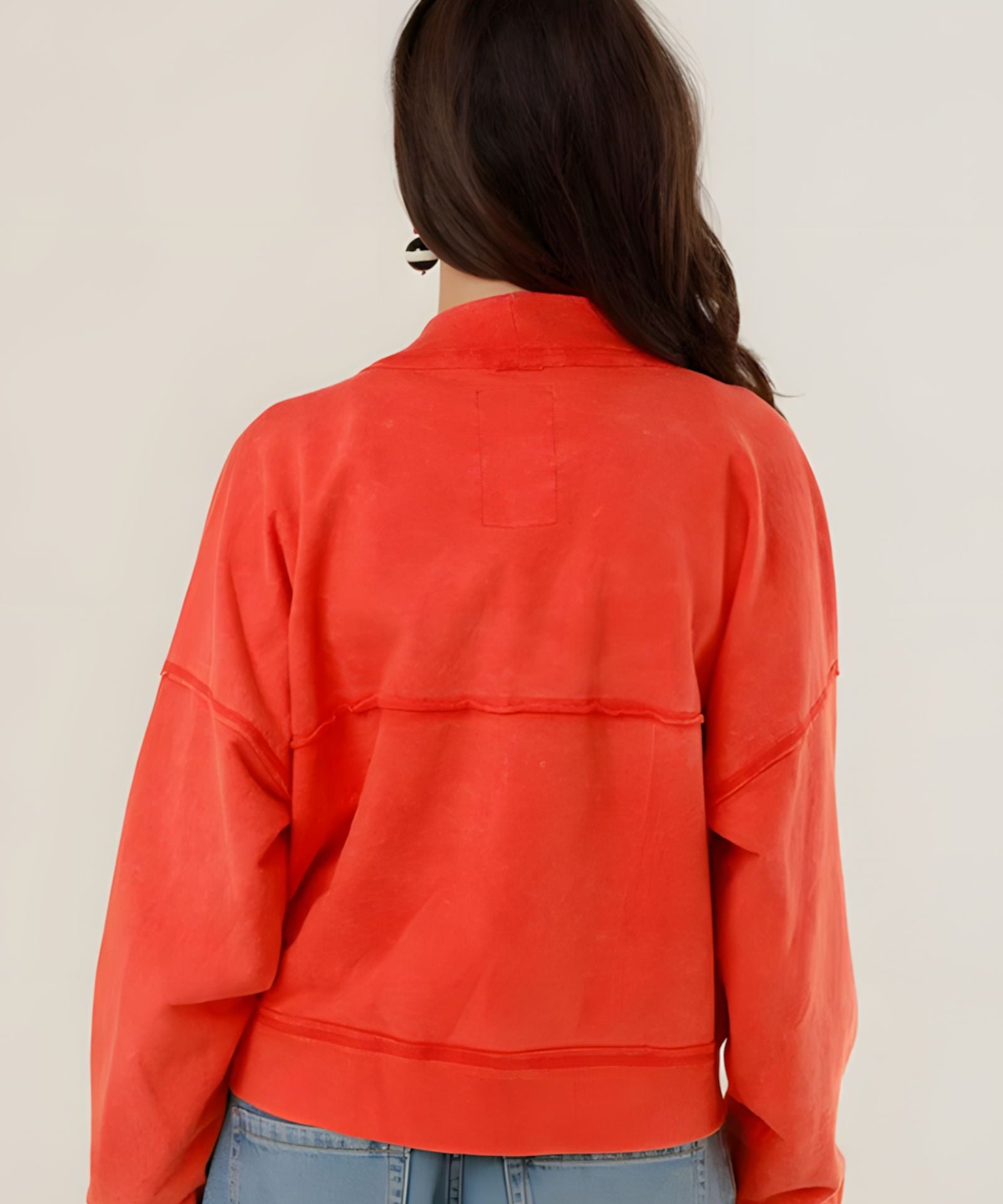 Rear view of the Azellia red acid-washed jacket on a model, showcasing its loose slouchy fit and back panel stitching details.