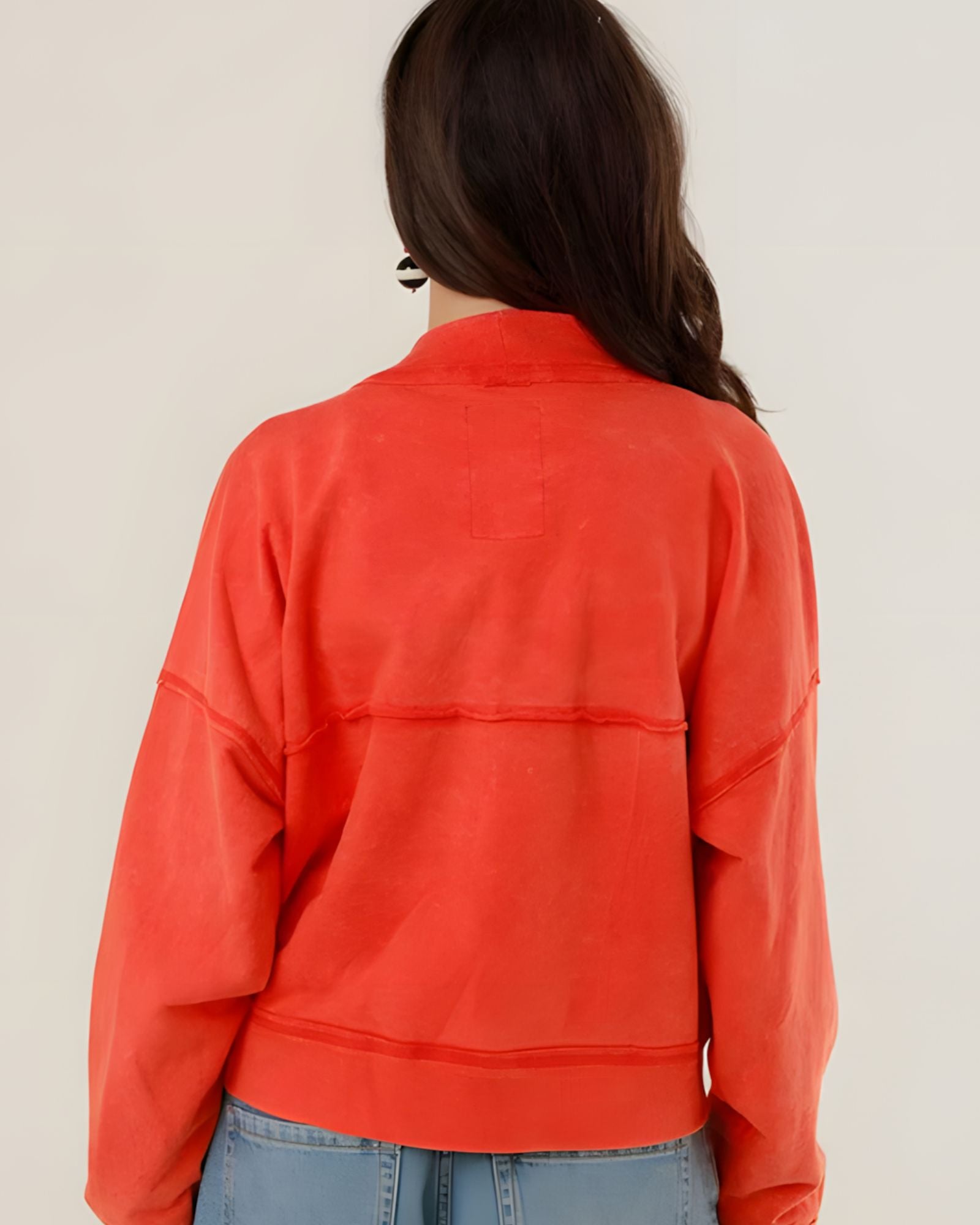 Rear view of the Azellia red acid-washed jacket on a model, showcasing its loose slouchy fit and back panel stitching details.