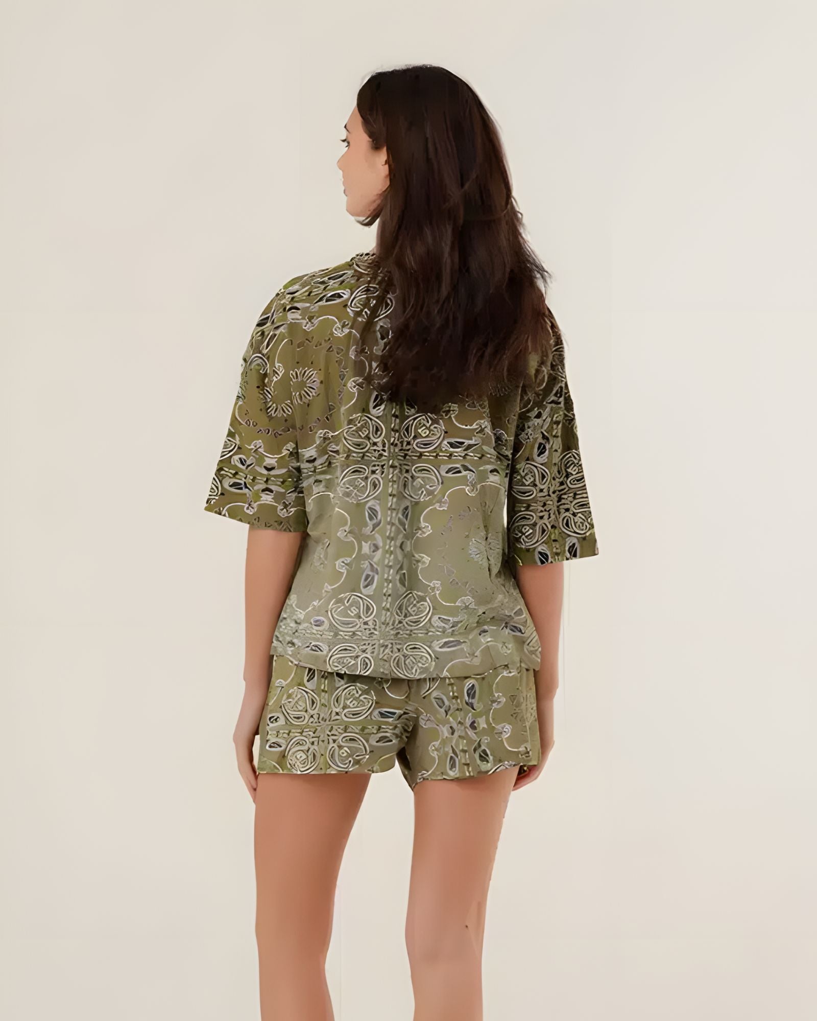Rear view of the green bandana print shorts on a model, showcasing the comfortable casual fit and all-over vintage pattern.