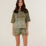 Full-length front view of a model wearing the relaxed fit green bandana print cotton shorts with a matching oversized patterned shirt.