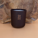 BYKOKO Havana Lovers scented candle on a wooden backdrop