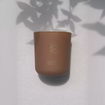 Bykoko Peony Romance 240g candle in a premium frosted glass vessel with a soft ambient glow