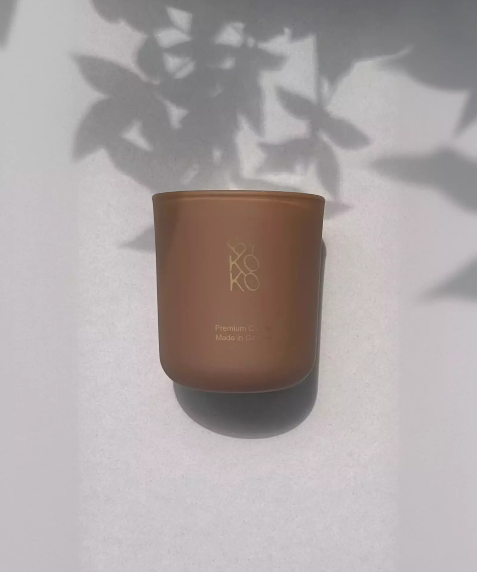 Bykoko Peony Romance 240g candle in a premium frosted glass vessel with a soft ambient glow
