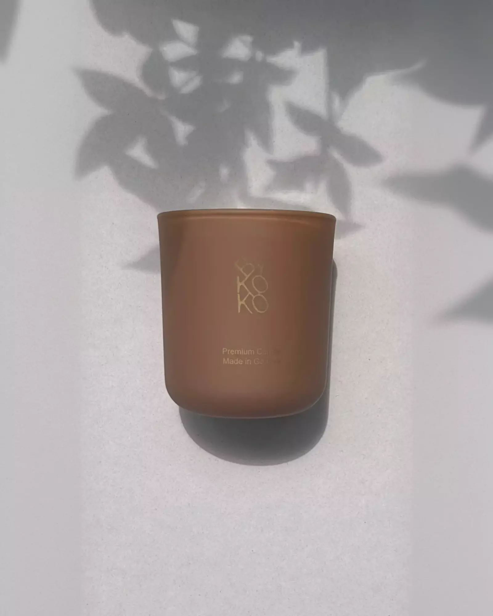 Bykoko Peony Romance 240g candle in a premium frosted glass vessel with a soft ambient glow