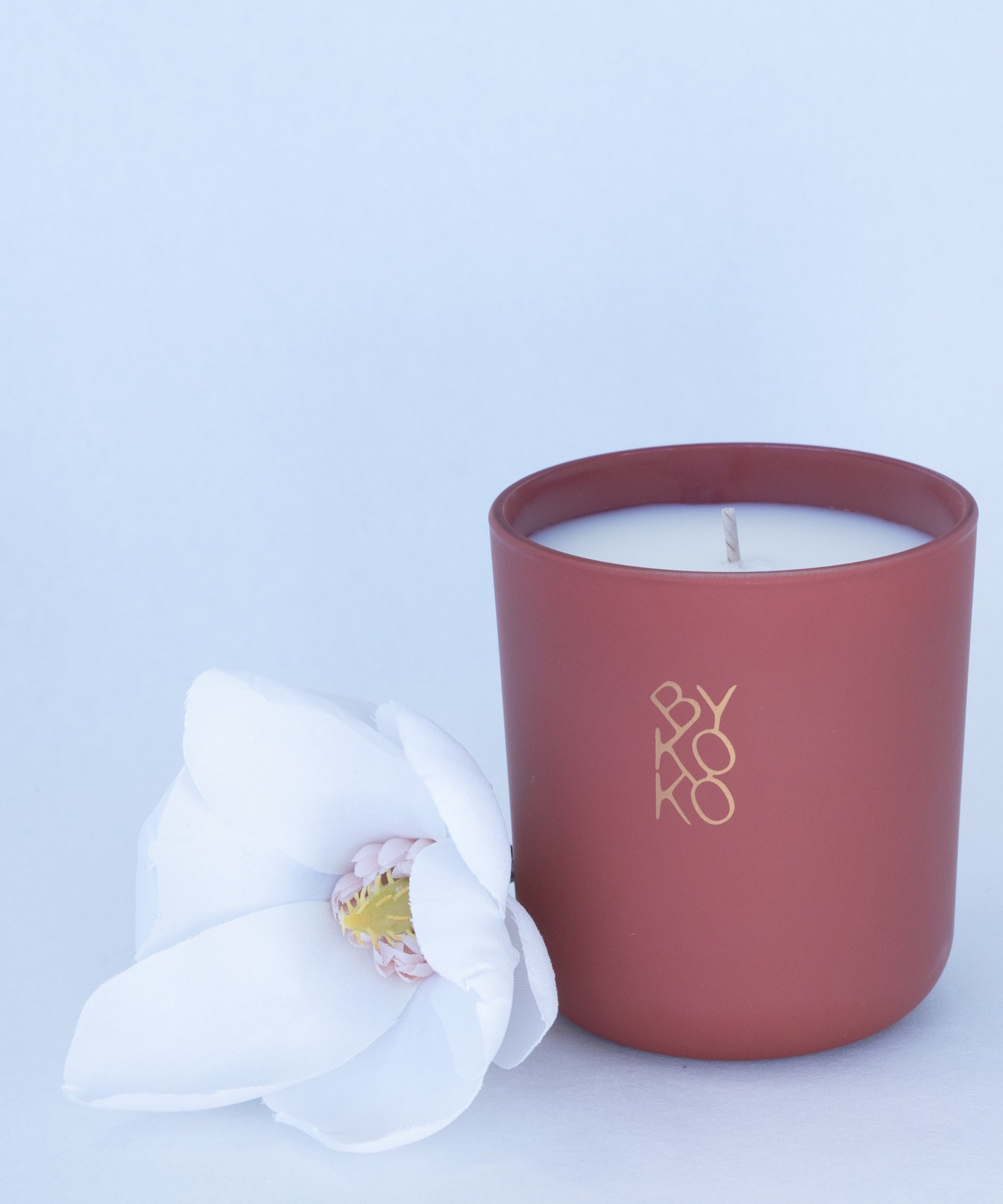 BYKOKO Peony Romance scented candle styled with a white flower