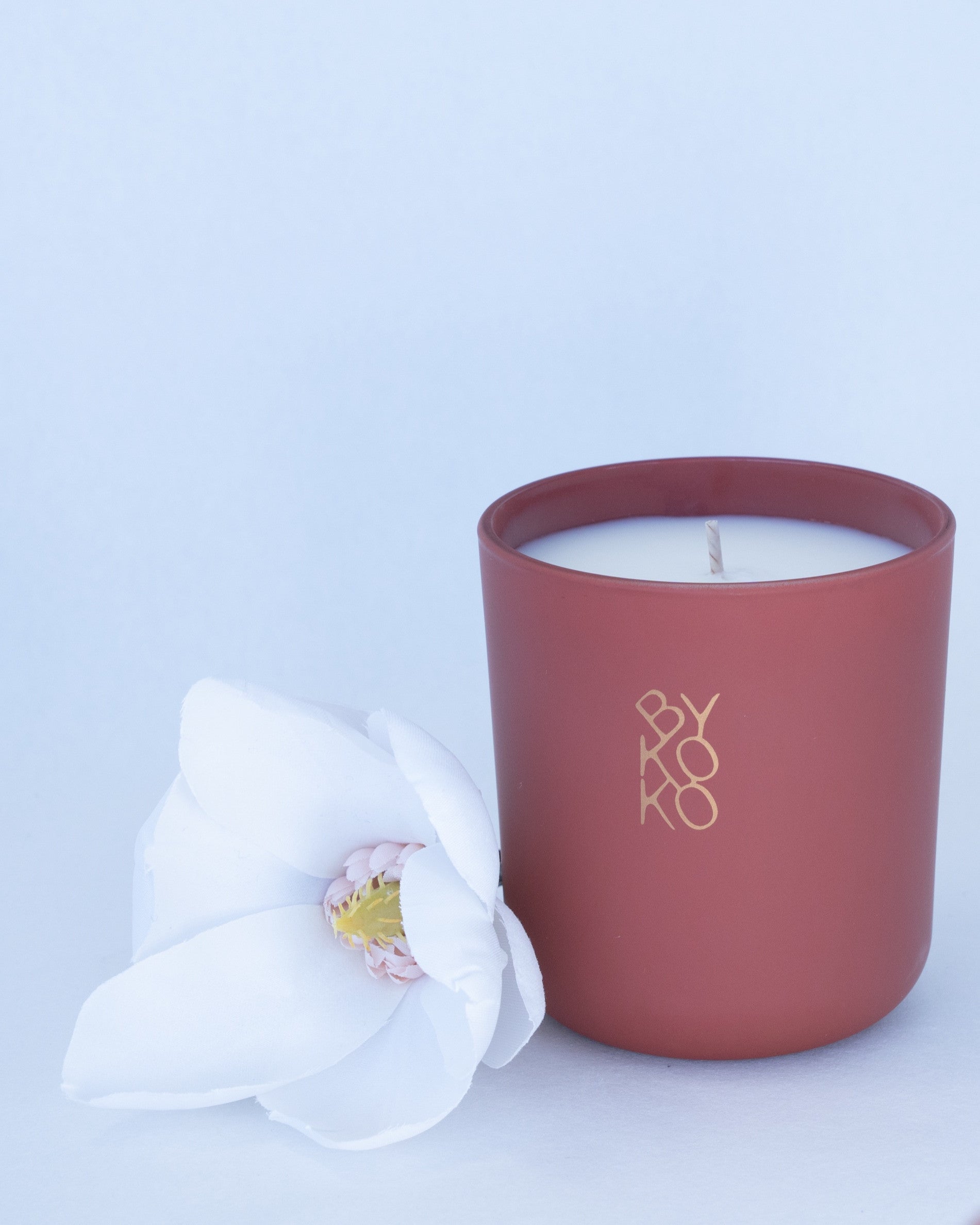 BYKOKO Peony Romance scented candle styled with a white flower