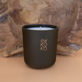 BYKOKO Swiss Chalet scented candle on a wooden backdrop