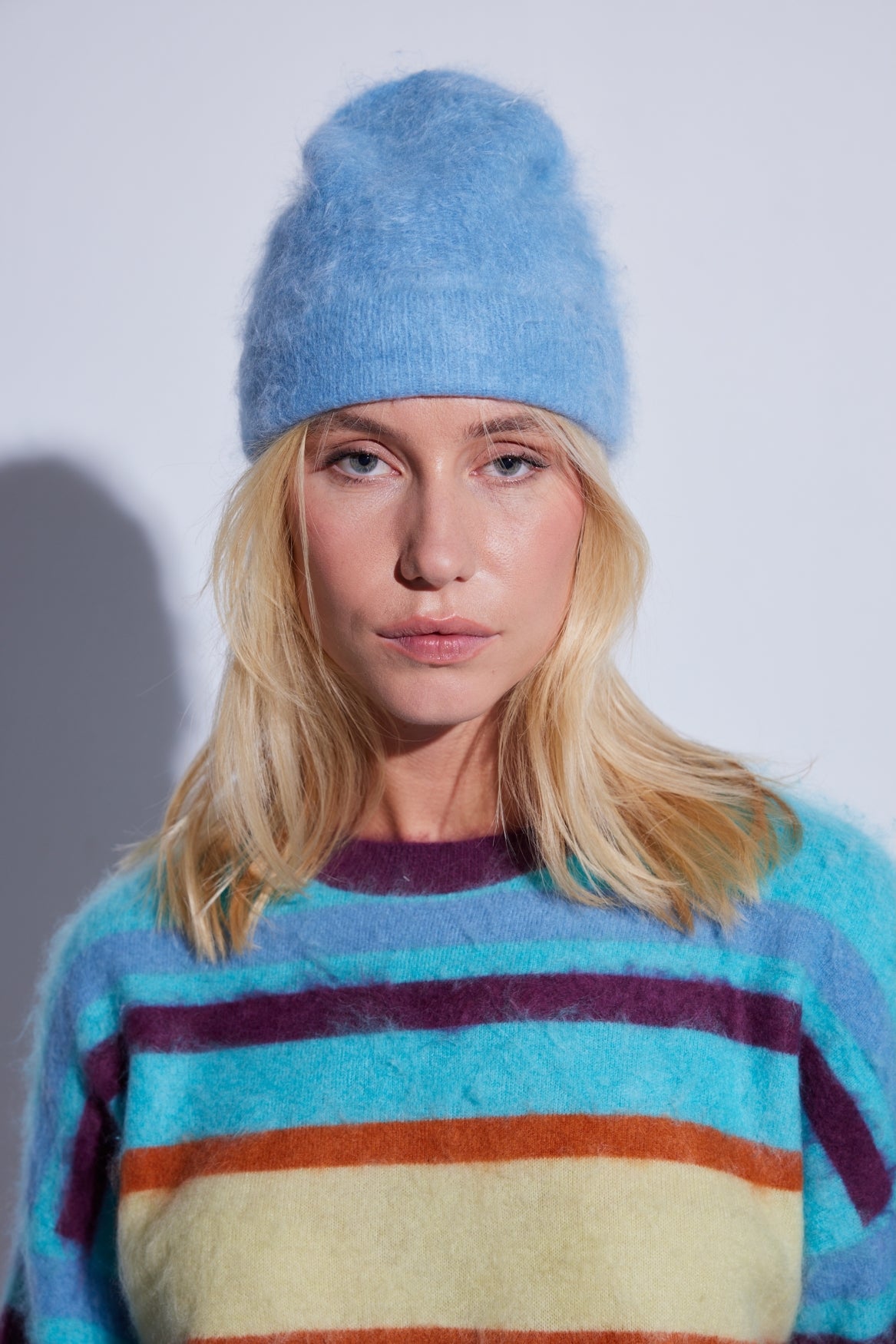 COLORUSH Byron beanie in Stonewash, worn with a multicoloured striped jumper