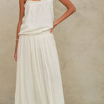 Model wearing the Mabe Apparel cream tiered maxi skirt paired with a white strappy cotton top.