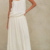 Model wearing the Mabe Apparel cream tiered maxi skirt paired with a white strappy cotton top.