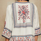 Close-up view of the detailed geometric back embroidery on a Mabe Apparel ecru jacket.