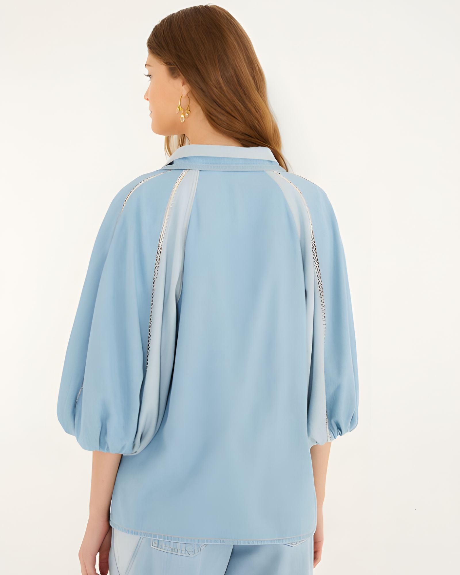 Rear studio view of the Farm Rio fluid denim blouse, highlighting the comfortable relaxed drape and voluminous puff sleeves.