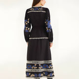 Full-length back view of the Farm Rio printed midi dress, showcasing the continuous embroidered patterns along the hem and sleeves.