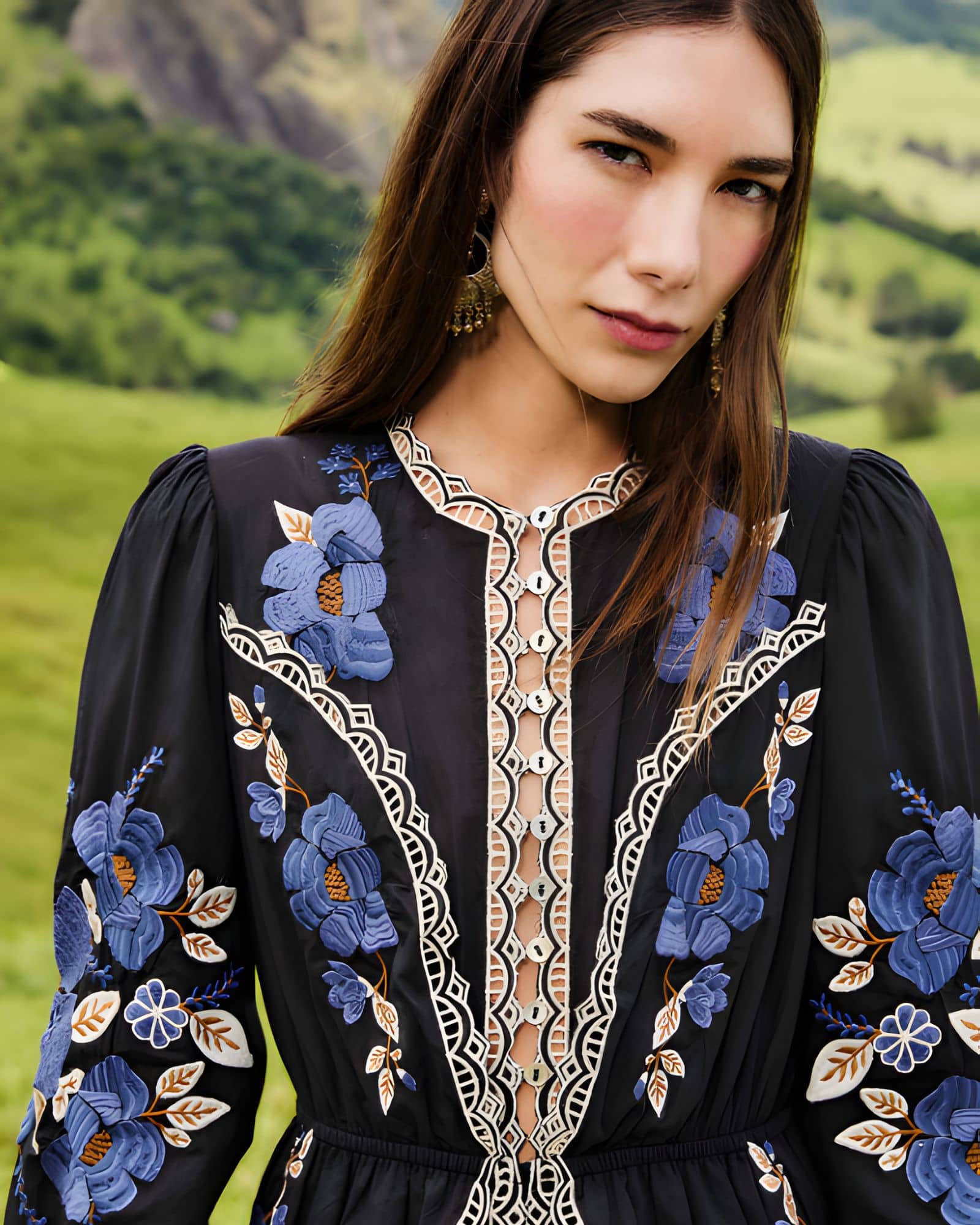 Medium portrait view of a model showcasing the detailed front bodice, lace open-work trims, and cinched waist of the Farm Rio embroidered midi dress.